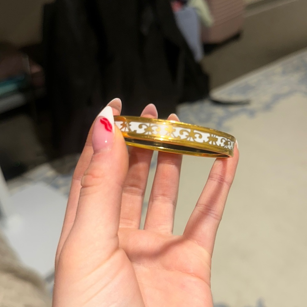 Hermés gold and white enamel bangle; in perfect condition